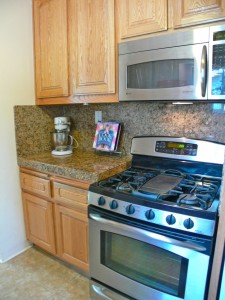 Stainless steel gas stove and built-in microwave.