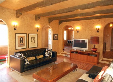Alternate view of sunken living room. The bonus room is behind the wall with the black sofa. Formal dining room is thru the doorway to left of the TV, and the foyer is to the right of TV. 3105 Pine St., Riverside