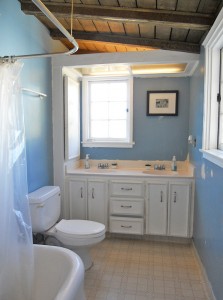 Upstairs bathroom with double sinks, large tub, and original glass mosaic flooring under linoleum. 3105 Pine St., Riverside