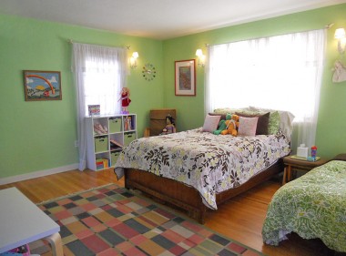 Large secondary bedroom with original hardwood floors, original lighting fixtures and walk-in closet with built-in chest of drawers and window. 3105 Pine St., Riverside