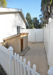 Fenced dog run with custom dog house and gate to the driveway parking area. 4734 Rubidoux Ave., Riverside