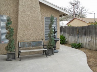 Walkway in front of home, leading to the front door which is to the right side of the home.