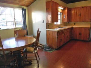 Alternate view of kitchen with amazing wood ceiling and dining area.