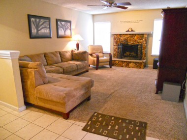 Lovely and spacious carpeted living room with gas and wood-burning fireplace.