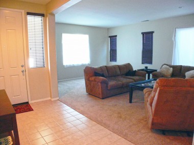 Front door and formal living room with newer carpet and paint!