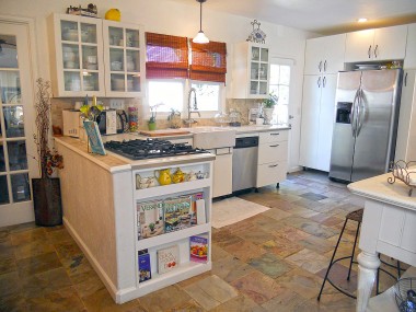 Feast your eyes upon this glorious remodeled kitchen, complete with slate flooring, built-in cookbook rack, glass-fronted cabinetry, and stainless steel appliances. 4081 Larchwood Pl., Riverside