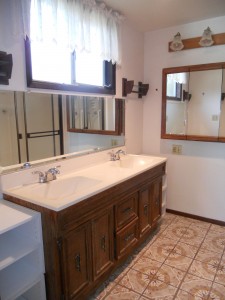 Private master bathroom with double vanity and large shower enclosure.