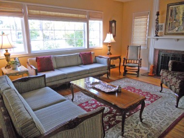 Elegant living room with gorgeous original hardwood floors and fireplace.