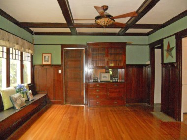 Formal dining room with plate rails, coffered ceiling, built-in hutch, large window seat and gorgeous original windows!
