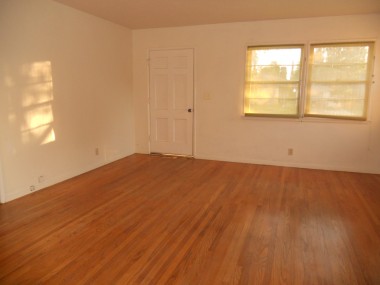 Living room with newly refinished hardwood floors.
