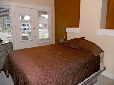 Third bedroom with carpeting and separate entrance.