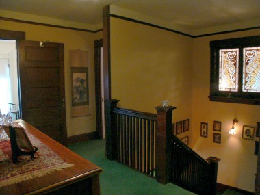 The upstairs landing with original leaded glass panels, which were indicative of the Prairie style homes from the late 1800s to the early 1900s.