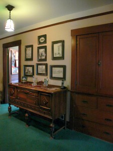 Alternate view of upstairs landing with linen closet, picture railing and original light fixture.