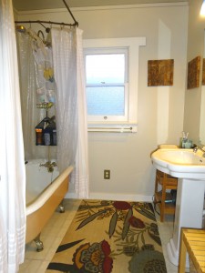 Claw foot tub in bathroom with upgraded pedestal sink. 