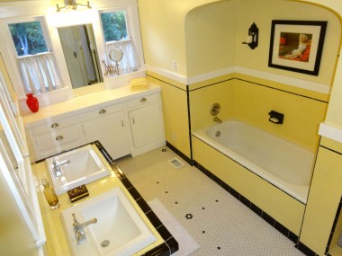 Hallway bathroom with double sinks, built-in makeup vanity and extra storage, along with soaking tub and a large walk-in shower with built-in seat.