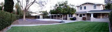 Panoramic view of double lot with large grassy area that would be ideal for a pool, especially because the droppings from the mature jacaranda tree rarely reach the grass for some reason. The dirt portion of the yard would be ideal for gardening! Grown your own non-GMO fruits and veggies!