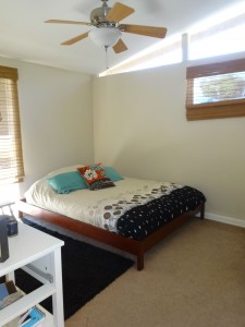 Second bedroom with ceiling fan, cathedral ceiling and ample closet space.