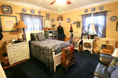 Front bedroom with original hardwood floors, ceiling fan, TWO closets, and lovely crown molding. 