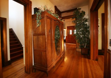 Servants' staircase to the left (next to the kitchen), and this hallway leads you full circle and back to the front entrance, the office enclave, and the downstairs bathroom. To the right are the pocket doors leading to formal dining room.