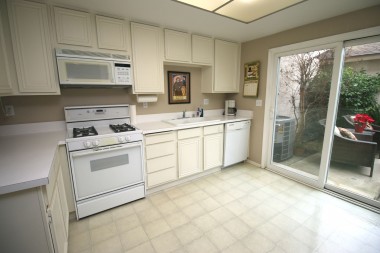 Spacious kitchen with gas stove, built-in microwave, dishwasher, and room for a preparation island.
