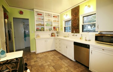 Alternate view of kitchen with open-style cabinetry.
