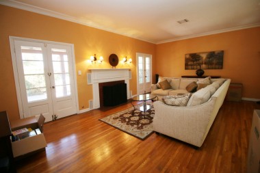 Spacious living room with two sets of French doors that lead to the charming back patio with outdoor fireplace!