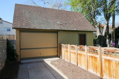 Garage was rebuilt with permits about 40 years ago. Two-car in size, but one-car size door, but tons of storage inside, including a stairway to an attic with even more storage!