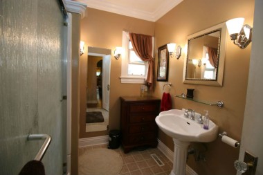 Remodeled hall bathroom with new tub, flooring, fixtures, and toilet. 