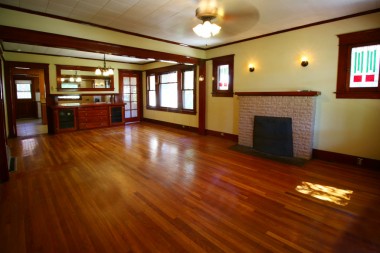 View as you walk through the front door. Wood/gas fireplace, ceiling fan, original hardwood floors, and original windows. Stained glass panels will be replaced prior to close of escrow.