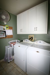 Separate laundry room with lots of cabinetry -- late model washer/dryer units are included.