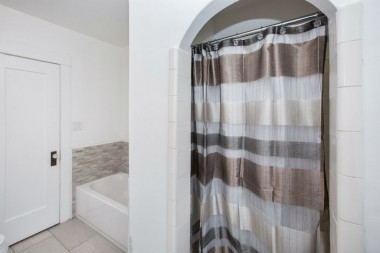 Soaking tub and shower stall in remodeled bathroom.
