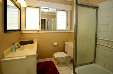 Hall bathroom with tiled shower in tub.