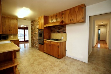 Retro kitchen with newer stainless steel appliances.