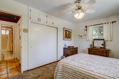 Alternate view of front bedroom with large closet and view of hallway bathroom shared by two bedroom.