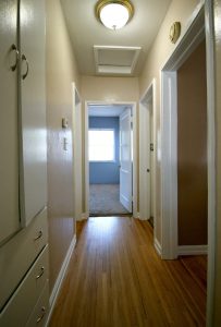 Hallway with newly refinished hardwood flooring.