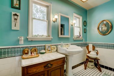 Guest bathroom with pedestal sink and tile flooring.
