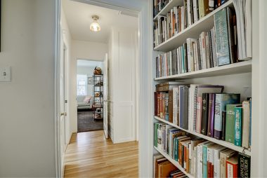Built-in hallway bookshelves leading to the secondary bedrooms.
