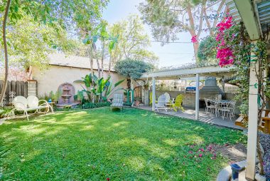 Soak up this gorgeous backyard complete with fountain, pergola, built-in BBQ, and original outdoor fireplace.