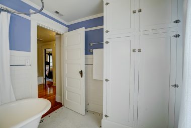 Alternate view of upstairs bathroom with plenty of linen storage.