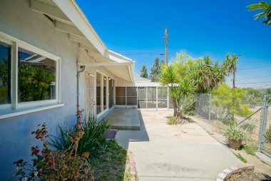 Low-maintenance paved portion of backyard with screened patio which is ideal for Al fresco dining or keeping your small pets safe from coyotes and hawks. The views are incredible from this back yard!