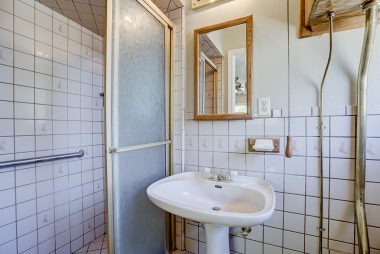 Master bathroom with pedestal sink and walk-in shower.
