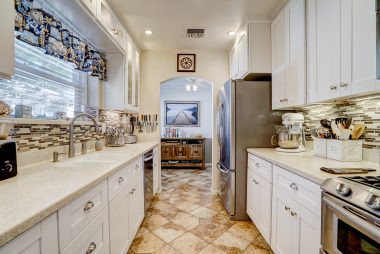 Spectacularly remodeled kitchen with Corian counter tops, stainless steel appliances, including dishwasher, built-in microwave, and soft-closing drawers.