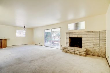 Spacious living room with fireplace and slider overlooking the patio and huge back yard.