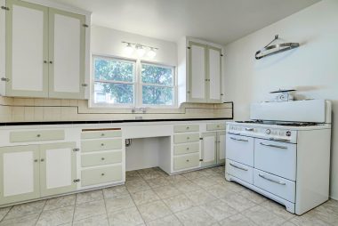 Adorable kitchen with antique gas stove and breakfast nook too.