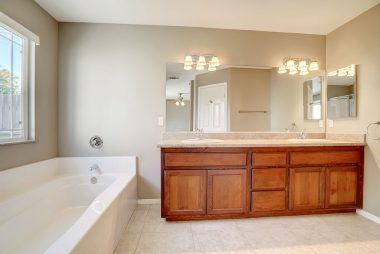 Master bathroom with double vanity, soaking tub, and separate shower.