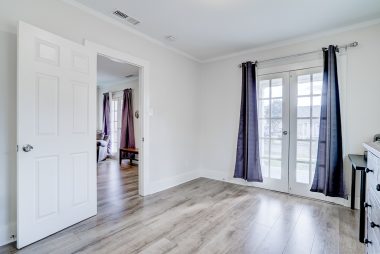 Front bedroom with French doors leading to front porch.