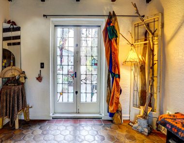 Alternate view of entry with original and amazing French doors with Jekel stained glass (note the parrot), overlooking the back patio.