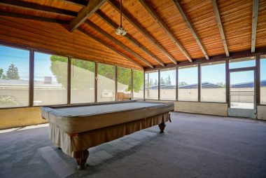 HUGE screened-in bonus room off the kitchen. There are windows to install during wintertime to maintain a comfortable temperature year round. Pool table not included.
