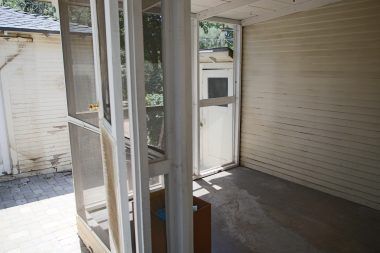 Screened-in porch off the back of the house. Was used as a catio.