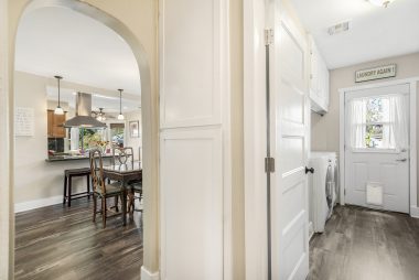 Rounded doorways add some charm, and convenience abounds with the indoor laundry room.